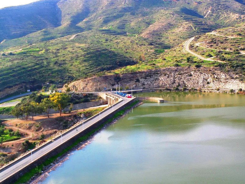 Germasogeia dam wall crossing the reservoir below the mountains